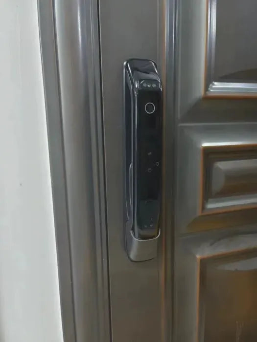 Face recognition smart door lock fitted to a grey panelled steel entry door