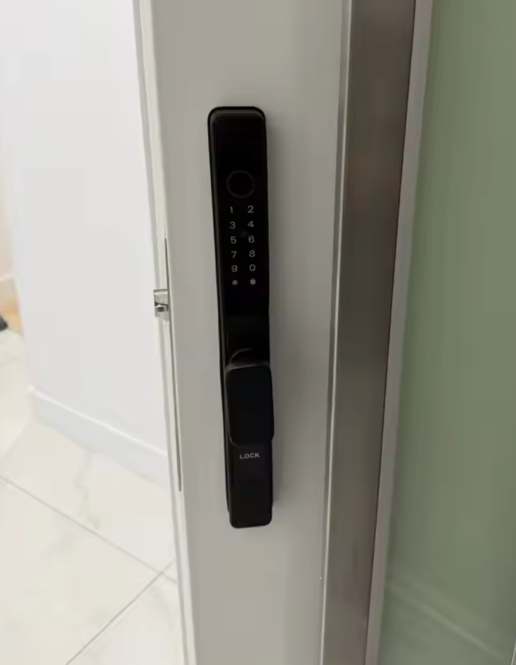 Black short-handle smart door lock fitted to a white interior door